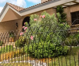 Reja Deacero Clásica frente a la fachada de una casa con un jardín